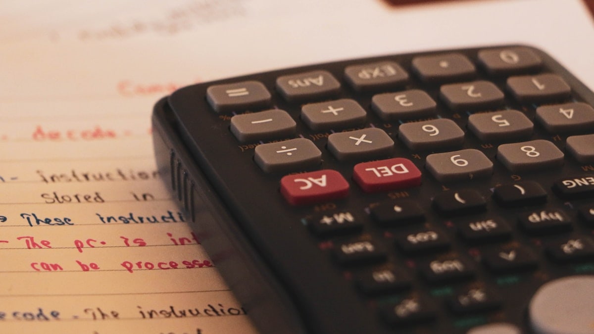A scientific calculator with paper work